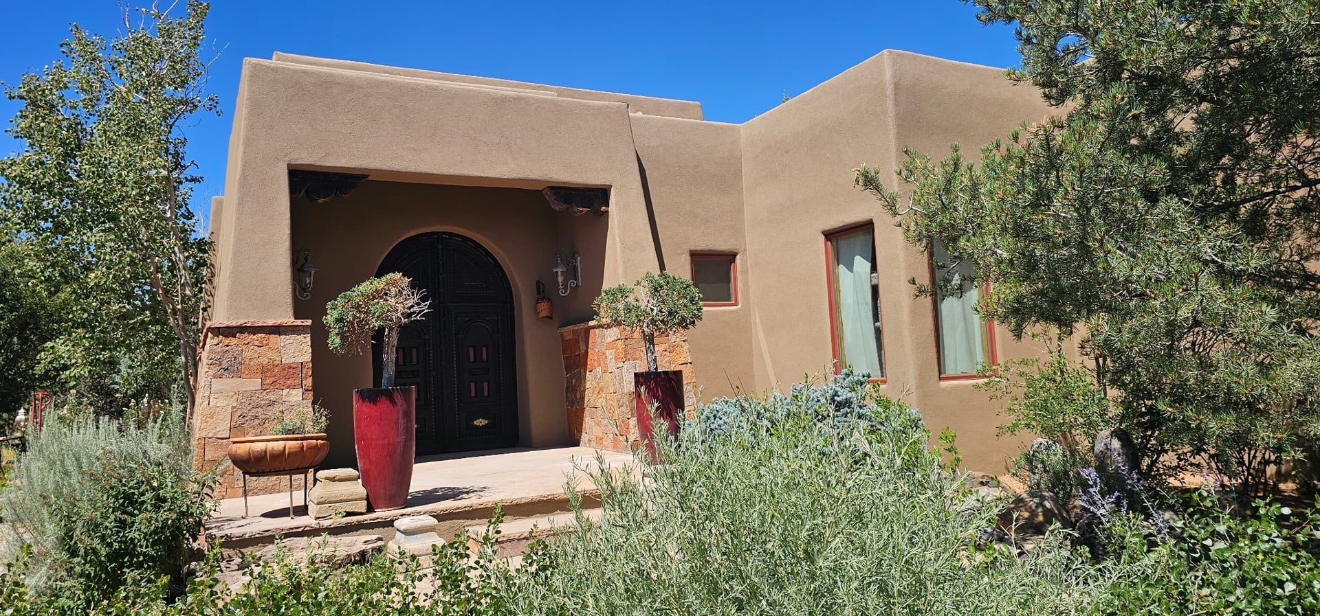 Finished stucco exterior and arched entry