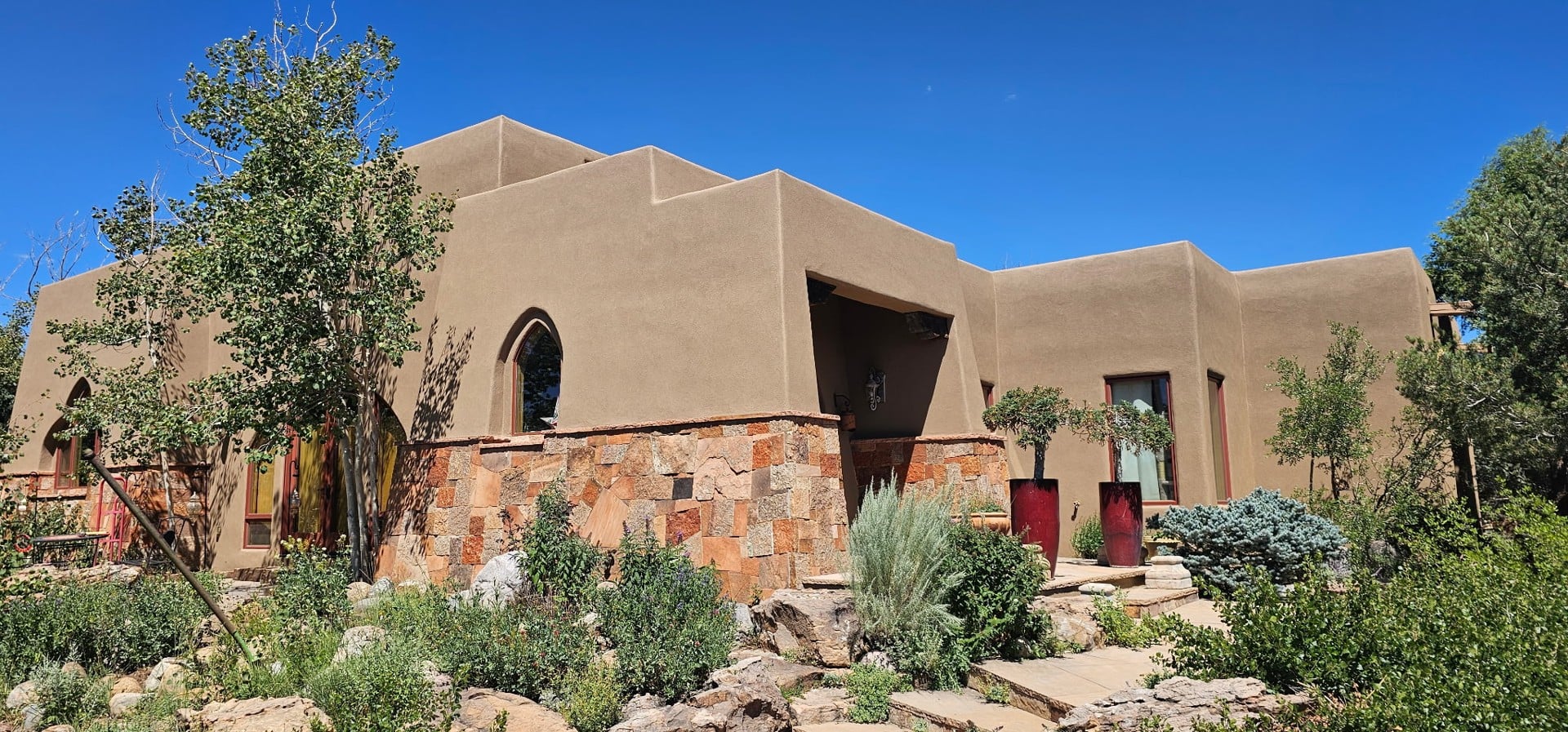 DBC project photograph of a stucco home surrounded by a landscaped garden